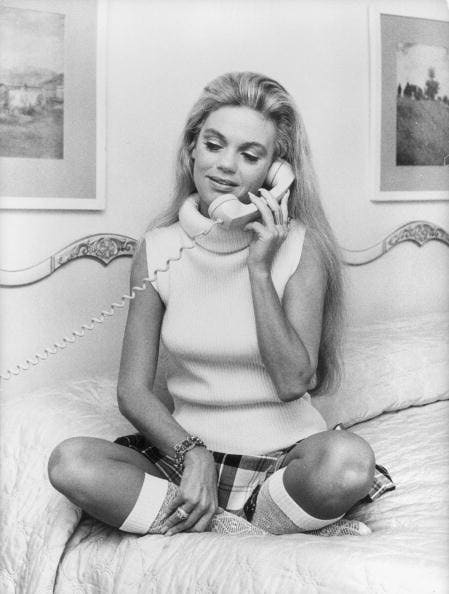 circa 1970:  American actress Dyan Cannon sits cross-legged to make a phonecall.  (Photo by Susan Schiff Faludi/Three Lions/Getty Images)